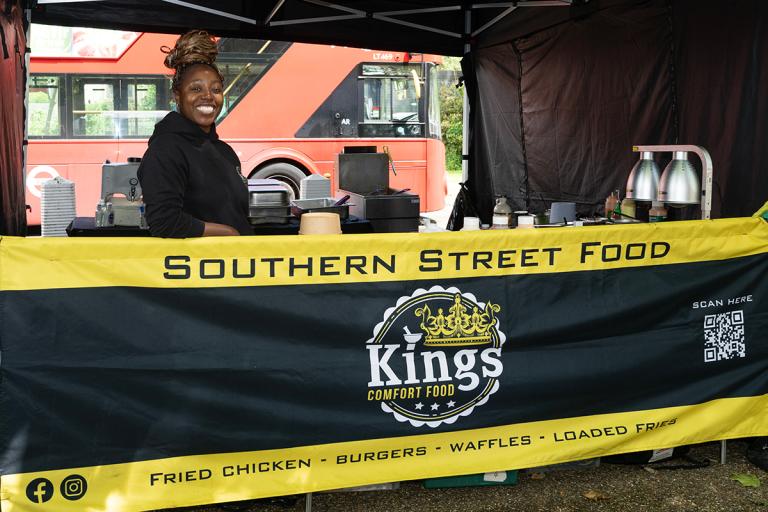 Black business owner at her market stall smiling